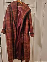 Front view of plaid ladies overcoat showing hood interior and lining, open front with no buttons