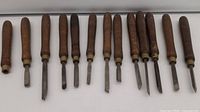 All 13 chisels lined up showing handles and blades
