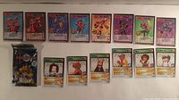 Overview of all fourteen cards and two sealed booster packs