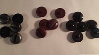 All 16 buttons grouped by colour: black, dark brown, grey