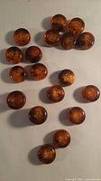 Group of 25 amber swirl buttons