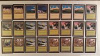 Full set of 24 black-border land cards laid out in grid