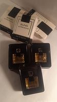 Three miniature Alfred Sung Sung EDT bottles in trays with boxes behind