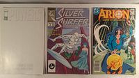 All three bagged comics: Powers #11 blank variant, Silver Surfer #2, Arion #8