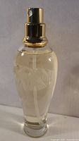Front view of 75 ml L'Air du Temps bottle showing gold spray top and liquid level