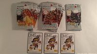 Seven empty MapleStory booster wrappers and three OMG code cards laid out