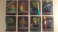 All eight foil cards laid out in two columns