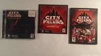 Front view of three City of Villains items: collector’s DVD, pre-order disc, manual