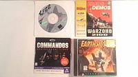 Overview showing four PC CD-ROMs: F-22 disc, Eidos Demos sleeve, Commandos jewel case, Earthsiege 2 jewel case