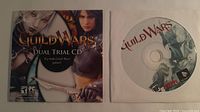 Front of sealed Guild Wars Dual Trial CD sleeve beside separate disc