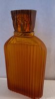Front view of amber ridged bottle with cap