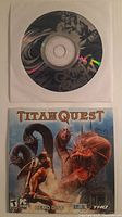Front view showing King's Quest VI disc in paper sleeve and Titan Quest demo sleeve front