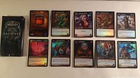 All nine foil cards laid out with Archives box