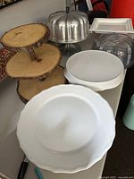 Photo showing all cake stands, Bundt cake carrier, and the 3-tier wood cupcake stand grouped on a table surface.