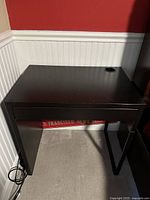 Small writing desk in espresso finish with single drawer and cable management hole