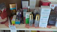 Overall assortment of boxed skincare and bath items on shelf with gingham cloth