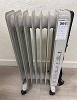 Side view of white oil filled electric radiator with control panel visible on the right side. Heater stands on small caster wheels.