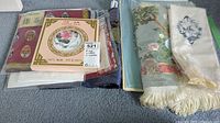Photo showing a collection of fine linens and scarves, some in packaging with Chinese silk labels.