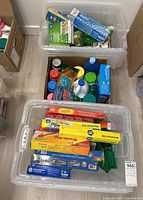 Three bins showcasing various boxed food storage bags, laundry cleaning liquids, and green reusable bags