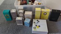 Eleven boxed perfume items arranged in bin front row