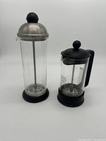 Photo showing both Bonjour Cafe Froth and Bodum coffee press next to each other against a plain background.