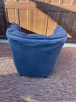 Back view of blue barrel back chair showing dotted fabric pattern