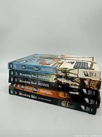 Side view of stacked Breaking Bad DVD box sets for all five seasons.
