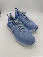 Front and top angled view of a pair of blue Hoka One One Bondi 6 running shoes with laces tied, showing mesh upper and cushioned sole.