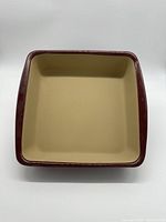 Top view of the square baking dish showing beige interior and brown rim.