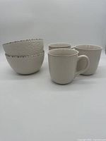 Five Pfaltzgraff Chateau pieces: 2 bowls and 3 mugs arranged in group