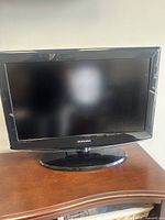 Front view of Samsung 26-inch LCD HDTV on black stand, screen off.