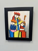 Front view of the framed colorful abstract painting showing three musicians playing instruments including a violin, a saxophone, and a double bass, with a black frame.