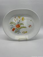 Front side of the oval plate showing the floral 'Wildflower' pattern with orange, yellow, pink, and blue flowers and green leaves.