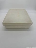 Top view of rectangular snack storage container with lid on, showing discoloration and wear.