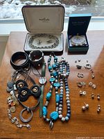 Full overhead view of all jewelry items on wooden surface