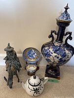Full view of all items including blue and white urn, Limoges teapot, porcelain cups and bronze figurine