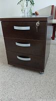 Full view photo of the locking espresso finish drawer unit showing three drawers on casters.