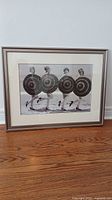 Full framed photograph showing four women in flapper style holding parasols on a beach, in a champagne colored frame and double matting.