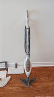 Full view of Shark Professional steam mop with triangular mop head attached and cord wrapped around handle.