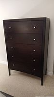 Front view showing five-drawer dresser in espresso finish with satin nickel knobs.