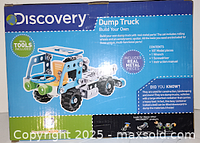 Front and side view of the Discovery Build Your Own Dump Truck kit box showing the assembled model and features