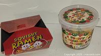 Photo of Squishy Ramen red cardboard box showing cartoon characters and logo