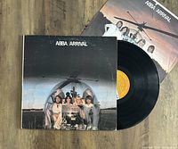 Vinyl LP record and album cover sleeve showing ABBA with a helicopter, worn condition.