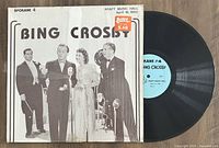 Black and white vintage album cover featuring Bing Crosby and other performers with microphones, text indicating Spokane 4 live at Kraft Music Hall on April 16, 1942, alongside the black vinyl LP record with a blue label