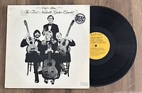 Vinyl LP record titled 'The First Nashville Guitar Quartet' by Chet Atkins, with album cover and record visible.