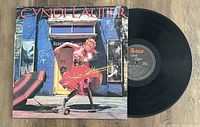 Photo of Cyndi Lauper She's So Unusual vinyl record with album cover showing cover art and record label.