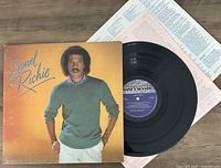 Vinyl LP record and album cover showing Lionel Richie with lyric sheet.