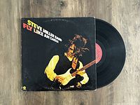 View of the Steve Miller Band Fly Like An Eagle LP album cover and vinyl record showing condition and artwork