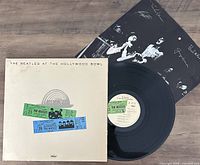 Vinyl record and cover with insert showing the Beatles album 'At The Hollywood Bowl' with two replica concert tickets on the cover.