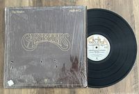 Photo showing The Carpenters vinyl LP titled 'The Singles 1969-1973' with album cover and record visible.